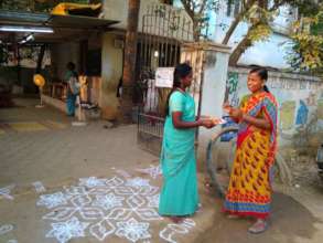 Staff welcoming a mother into the Pudiyador center