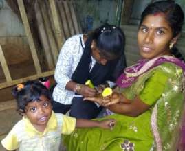 A mother+child getting henna at a mothers retreat