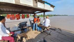 CIF staff on a ferry to get to a remote village.