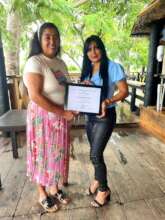 Yronelis (right) receives her diploma