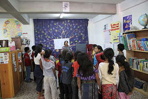 Students crowd around Lidia, our librarian