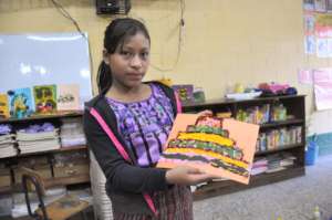 A student shows off her collage