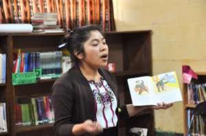 Ms. Clara reads aloud to students