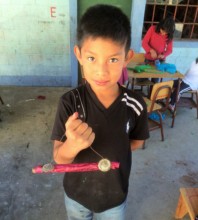 Showing off his handmade instrument