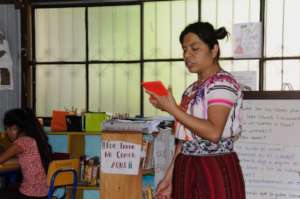 Lidia reads a story aloud using a tablet