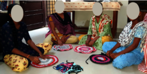Shyama with other survivors making doormats