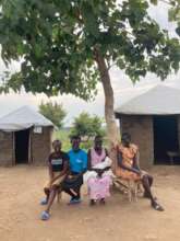 Refugees under one of "our" trees providing shade