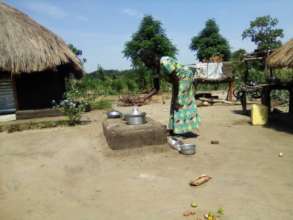 A refugee cooks on an energy saving stove