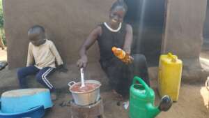 Betty cooks beans on an energy conserving stove
