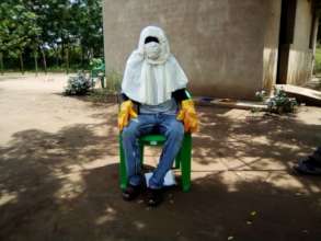 Nursery worker in protective gear against COVID