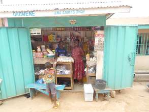 Ama & her nephew attend to a customer at her store