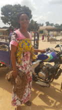 Akua proudly displays her "aboboyaa" or tricycle