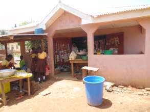 in front of Saudatu's store