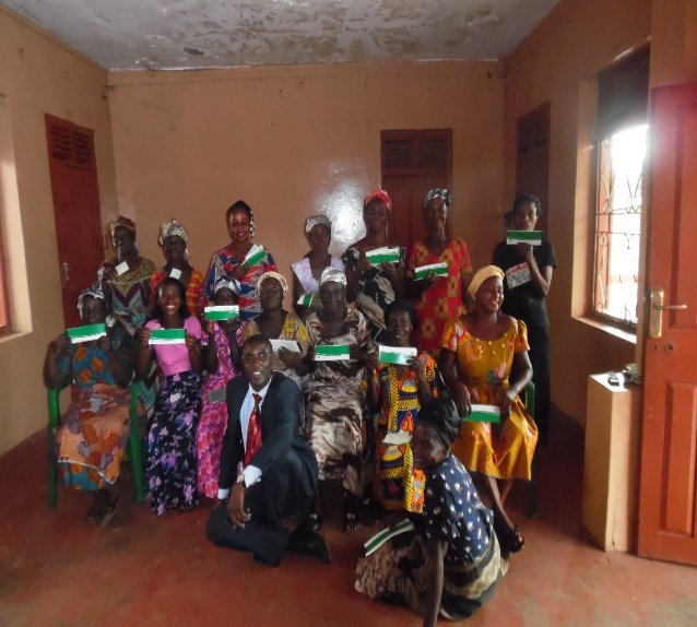 a group of people pose holding their new checkbooks