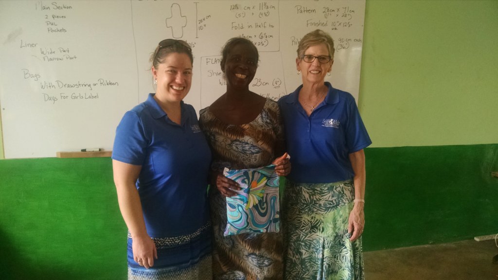 Nora (L) and Gail (R) present Olivia with a prize
