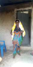 Salamatu in front of her home