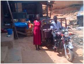 Sarah and her husband with tricycle