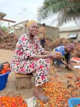 Woman with palm fruit.