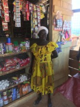 Adwoa in front of her shop.