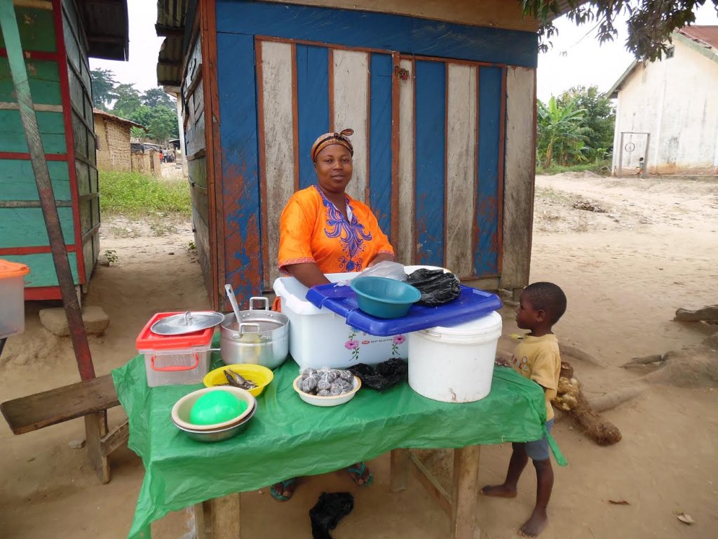 Lucy selling food in her community.