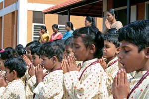 Children praying before the classes start