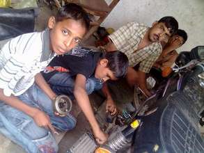 Talking to children working in auto-repair shops