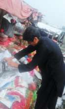 Sher Ali collecting trash at the local market