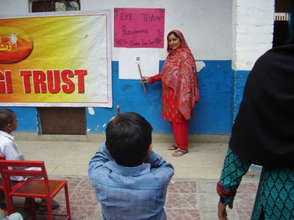 A teacher conducts an eye exam for a student