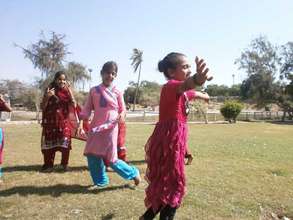 Children play an outdoor game at the school picnic