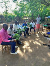Relaxing in the shade, holding the harvest.