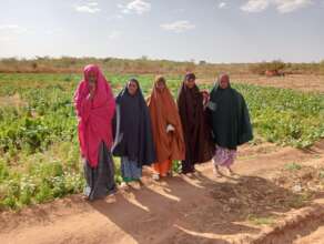 Some of the women in front of their gardens