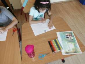 Child from Afumati working on our handouts