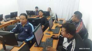 Our teacher preparing the students report's book