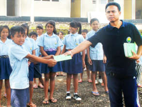 Students receiving report book from our teacher