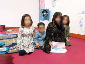 A mourning family in Herat receiving aid