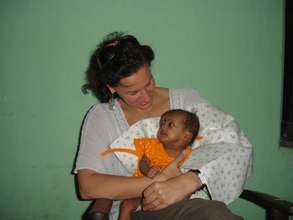 Caroline comforting an infant