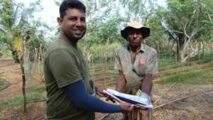 Distributing the incense sticks to the farmers
