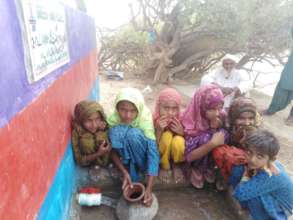 Children filling their pitchers with sweet water