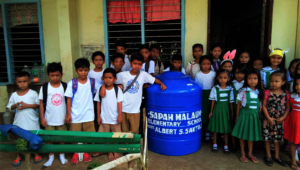 Students surrounding the new water tank