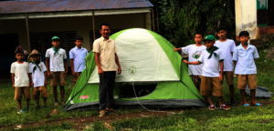 Boy scouts prepare tent for camping