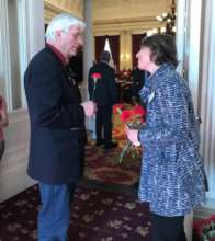 Julia Hampton (VT-SPC) hands flower to legislator