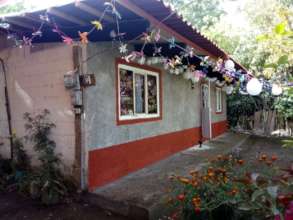 Gloria celebrating her repaired house.