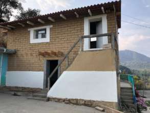 Adobe houses rebuilt with your support.