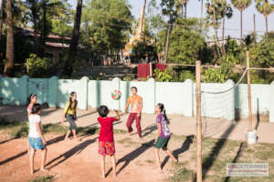 Girls play volleyball in peripheral area of Yangon