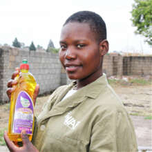 Tatenda with bottled Clean Girl soap in Harare