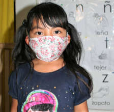 A young girl shows off her new mask