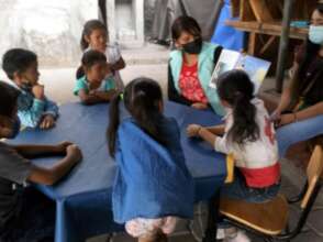 Early Stim - Older children enjoy a book