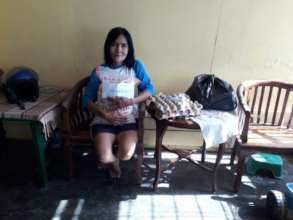 A local resident holding supplies just received