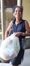 mother picking up her bag of goods