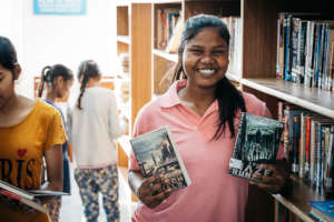 Sareena checking out books from the library